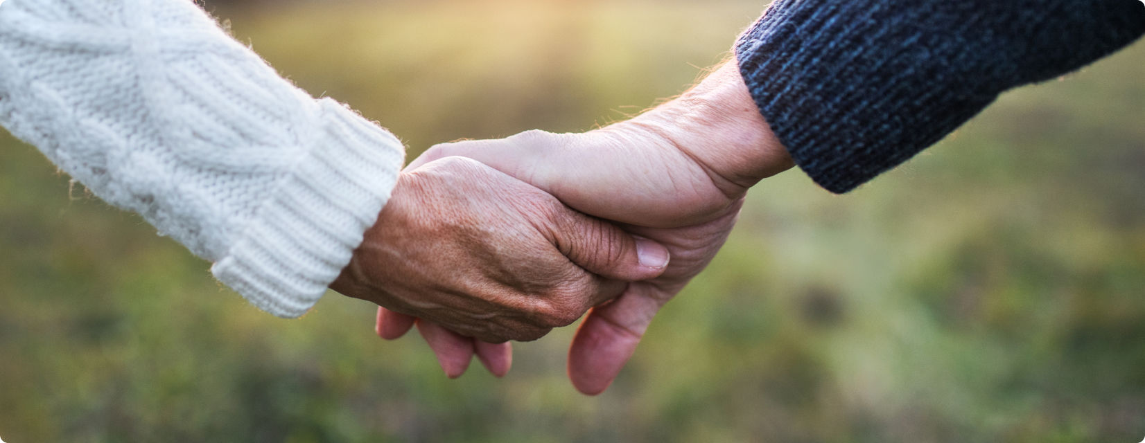 An older couple holding hands